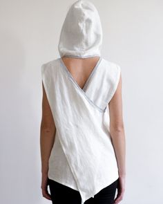 "Linen top with roomy hood and pockets. Loose shape and interesting cut. Perfect choice for hot summer days! The hood can be raised in wind or to protect against the sun, but can also be neatly draped on the shoulders to create another fresh look. Model is wearing size M blouse in creamy white. Each piece is individually cut, sawn and pre-washed. We really love making various sizes - from petit to plus size and more. For the best fitting of this shirt please let us know the following measurement White Drawstring Hood Top For Summer, White Drawstring Hooded Top For Summer, White Hooded Tops For Summer, White Summer Top With Drawstring Hood, Hooded Beach Tops For Spring, Hooded Summer Beach Tops, Hooded Beach Tops For Summer, Summer Tops With Drawstring Hood And Relaxed Fit, Summer Tops With Drawstring Hood Relaxed Fit