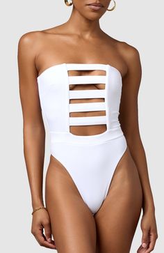 This one-piece is the perfect combination of classy and sexy. Boning and silicone elastic keep this strapless one-piece up and in place so you feel comfortable and secure. Ultra soft material, strapless, double lined Brazilian bottom coverage High cut at hips elongate the legs Elastic in waistband cinches in waist Elegant Strapless Summer Bodysuit, Strapless Stretch Swimwear For Club, Chic Strapless Bodysuit For Beach, Elegant Bandeau Bodysuit For Summer, White Strapless Bodysuit For Summer, Strapless Lined Bodysuit For The Beach, Chic Strapless Bodysuit With Lined Body, Fitted Strapless Bodysuit For Pool, Fitted White Tube Top For Pool