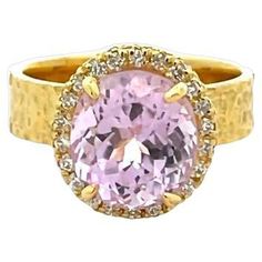 Our kunzite ring will undoubtedly captivate your heart with its stunning gemstone that glimmers with every movement. The centerpiece of this magnificent ring features a remarkable 4.84-carat kunzite that is elegantly surrounded by 0.20 carats of dazzling round white diamonds. It makes this ring with 5.04 total carat weight. This ring is crafted from 18K yellow gold, adding a touch of luxury and sophistication to this impressive piece with the hammered finish Incredibly textured, you may be able to feel the indents if you run your finger over the metal. With a finger size 6.5, this fashionable ring is a must-have accessory that will elevate any outfit to the next level. Tell us your preferences, and we'll customize this jewelry for you. You don't need to settle for anything less than perfec Luxury Kunzite Ring, American Art Deco, Kunzite Ring, Vintage Cocktail Ring, Diamond Cocktail Ring, Diamond Cocktail Rings, White Diamonds, Cocktail Ring, Cocktail Rings