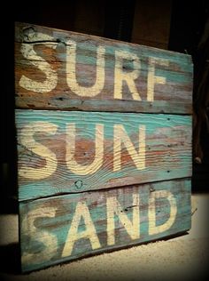 an old wooden sign that says surf sun sand on the front and back of it