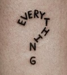 the word everything is written in cursive writing on someone's arm,