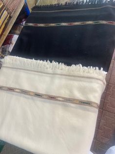 This classic Swat-Islampuri woolen shawl is hand knitted by skilled artisans in the Swat Valley of Pakistan. It is made from pure wool, which makes it warm and comfortable to wear. The shawl is available in a variety of colors, so you can choose one that matches your style. It is perfect for keeping you warm in the winter or for adding a touch of elegance to your outfit. Here are some additional details that you can include in your description: The shawl is made from 100% pure wool. It is hand k Traditional White Scarves For Winter, Traditional White Winter Scarves, Traditional Shawl-style Dupatta With Border, Traditional Shawl Shaped Dupatta With Border, Traditional Dupatta Shawl With Border, Traditional Dupatta With Border In Shawl Shape, Traditional Winter Shawl For Gift, Traditional Handwoven Black Shawl, Traditional White Handloom Shawl