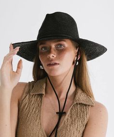 Keep the sun rays at bay with our raffia straw Ozzy Lifeguard Hat. Indulge in versatility with our relaxed a-line wide brim hat, where style seamlessly meets functionality. The intricately woven straw boasts a tight weave, providing optimal sun protection for all your outdoor escapades. Size: 57 (S/M) Adjustable Black Straw Hat Made Of Paper Straw, Black Panama Hat For Summer Travel, Black Toquilla Straw Fedora For The Beach, Black Fedora Panama Hat For Travel, Black Straw Hat For Summer Travel, Black Toquilla Straw Panama Hat For Summer, Black Straw Panama Hat For Travel, Black Brimmed Panama Hat For Travel, Chic Braided Straw Sun Hat