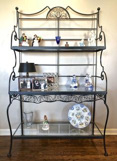 This vintage, metal Bakers Rack is in pristine condition, having been kept indoors by it's only owner since it was purchased in the early 70's. The manufacturer was a firm called Russell Woodard. It's solid wrought iron with a handsome scroll design. The glass shelves are in near mint condition with only a few minor scratches that I could see. It measures 70 tall x 42 across x 18 deep. This is a wonderful Mid-Century piece for storing your collectibles, plants, etc. Contact me before you purchas Metal Bakers Rack, Wrought Iron Patio Furniture, Wrought Iron Furniture, Bakers Rack, Iron Furniture, Scroll Design, Glass Shelves, Indoor Furniture, Storage And Organization