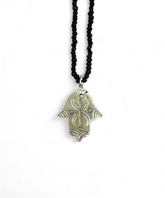 This necklace was made by a craftsman in southern Morocco, in the Anti-Atlas region. The necklace is made of Berber silver, it is not hallmarked, but it bears the blacksmith's signature on the back. This necklace is a protective talisman. The hand of Fatima, also called khamsa, or hand of Fatima, is a symbol used mainly in North Africa to protect against the evil eye. Its symbol is very present in Berber customs and beliefs, where it serves as protection and a good luck charm. The symbol represe Silver Beaded Necklace With Black Beads As A Gift, Silver Beaded Necklaces With Black Beads For Gift, Symbolic Necklace With Oxidized Finish, Symbolic Adjustable Necklace With Oxidized Finish, Black Amulet Style Necklaces With Polished Beads, Symbolic Necklace With Oxidized Finish And Adjustable Fit, Black Amulet Necklaces With Polished Beads, Black Amulet Necklace With Polished Beads, Handmade Artisan Ankh Jewelry