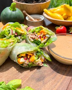 lettuce wraps filled with meat and vegetables on a cutting board next to dipping sauce