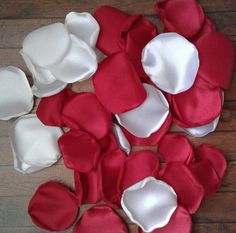 several red and white pieces of cloth on a wooden floor