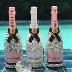 three bottles of champagne sitting next to each other