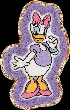 an embroidered patch with a cartoon character on it's face and purple, gold and white background