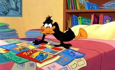 a cartoon character laying on top of a bed next to a pile of books in a bedroom