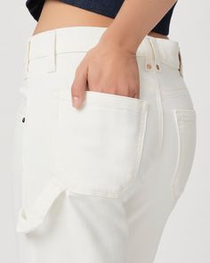 Rion is our new high-rise carpenter pant with a loose, relaxed fit. Crafted from super soft tonal ecru denim with a hint of stretch for comfort, this pair is designed with classic carpenter styling details, mixed metal hardware, and outside ankle seam slits. | Rion Carpenter Straight Jean - Tonal Ecru | Size 34 White High-rise Utility Cargo Jeans, High Rise White Cargo Pants For Work, White Utility Jeans For Work, White Utility Bottoms For Everyday, White Spring Cargo Jeans With Hip Pockets, White Cargo Jeans For Workwear, Spring White Cargo Jeans With Hip Pockets, White Cargo Jeans With Hip Pockets For Spring, White Cotton Cargo Jeans For Work