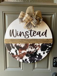 a door with a sign that says,'winstead'on it and a bow hanging from the front