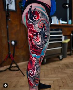 a person with tattoos on their legs and leggings in the shape of a dragon