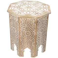 an octagonal wooden table with intricate carvings on the top and sides, made from wood