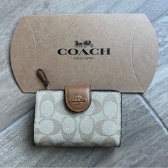 Signature Coated Canvas And Smooth Leather Seven Credit Card Slots Bill Compartment Id Window Snap Closure Zip Coin Pocket 5" (L) X 3 1/2" (H) X 1/2" (W) Style No. C0082 Coach Beige Coin Purse With Card Slots, Coach Card Wallet, Beige Wallet With Original Box As Gift, Coach Bifold Coin Purse Gift, Rectangular Coach Coin Purse For Gift, Classic Beige Coin Purse As Gift, Beige Bifold Coin Purse As Gift, Classic Beige Bifold Coin Purse, Designer Beige Wallets For Gift