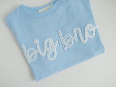 Ready To Ship big brother t-shirt! This listing is for one blue 'big bro' t-shirt, size 4T. The text is created in white felt and hand-stitched with blue ombre thread (as shown). The shirt cannot be changed or customized. ----- - DETAILS - This listing is for one size 4T blue, short-sleeve, hand-embroidered 'big bro' t-shirt as shown. This t-shirt is ready to ship and cannot be customized. Ready to ship shirts ship within 2 business days unless ordered with a custom item. - ADDITIONAL INFORMATIO Baby Announcement Shirt, Big Brother Tshirt, Baby Announcement Shirts, Felt Name, Big Brother Shirt, Sibling Shirts, Brother Shirts, Mama Sweatshirt, Embroidered Tshirt