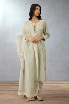 Sage green kurta with dori embroidery and shell tassel. Paired with embroidered salwar and embroidered dupatta.
Component: 3
Pattern: Embroidered
Type Of Work: Hand Adda and Dori Work
Neckline: Notched
Sleeve Type: Long Sleeves
Fabric: Kurta: Handwoven Chanderi, Cotton Voile; Salwar: Handwoven Chanderi; Dupatta: Silk Organza
Color: Green
Other Details: 
Tassel detail
Embroidered dupatta
Occasion: Destination Wedding, Wedding - Aza Fashions Organza Kurta Set, Organza Kurta, Organza Suits, Organza Embroidery, Kurta Set For Women, Kurta Designs Women, Indian Suits, Boutique Dress Designs, How To Hem Pants