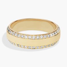 a yellow gold ring with white diamonds on the inside and outside, set in 18k gold