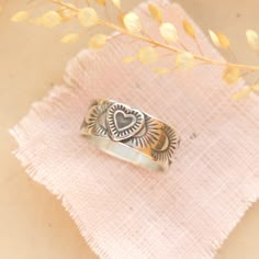 As sweet as could be. A little intricate heart is set on a stamped silver band. Versatile enough to stack with others or wear alone. 8mm wide. Bright sterling silver. Choose your ring size during checkout. Because this is a band ring, we recommend ordering a 1/2 size larger. The design is hand stamped, so slight variations can occur. Please allow 1-2 weeks for your ring to be made to order. ________________________________ Sizing: Your ring will be made to order. Please make sure you are orderin Handmade Bohemian Heart-shaped Rings, Finger Bracelets, Hand Stamped Ring, Valentine Ring, Heart Stamp, Moonstone Stone, Homemade Jewelry, Jewelry Lookbook, Western Jewelry