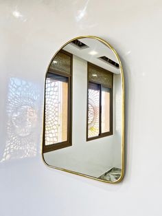 a mirror hanging on the side of a wall