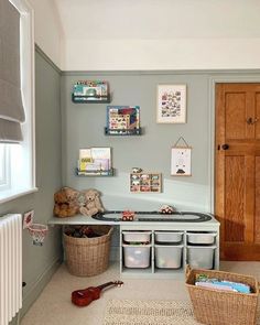 a child's playroom with toys and storage bins