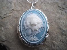 Beautiful cameo locket!!!  The cameo is beautifully detailed!!!  Wonderful gift for sisters, mothers, daughters, and friends!!!! The locket is victorian style with beautiful scroll on the front and back about 1 3/4" long.  It can hold two photos, keepsakes, or even your daily medication or vitamins!!! Pass down from generation to generation!!! The chain is 22"  1.2mm .925 plated snake chain with a lobster claw clasp!!! Perfect  for Brides or Bridal parties.  Makes a unique memorable gift for any Cameo Medallion Jewelry For Anniversary, Cameo Round Pendant Necklace For Wedding, Wedding Necklaces With Cameo Round Pendant, Cameo Medallion Locket Necklace For Keepsake, Cameo Medallion Locket Necklace Keepsake, Elegant Cameo Locket Necklace For Wedding, Blue Cameo Necklace For Wedding, Blue Cameo Jewelry For Wedding, Keepsake Medallion Locket Necklace With Cameo