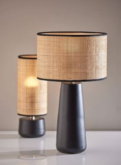 two lamps sitting next to each other on a table