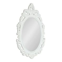 a white oval mirror on a white wall with an ornate design around the edges and sides