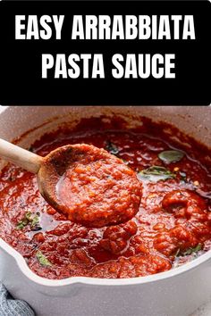 the sauce is being stirred with a wooden spoon to make easy arrabiata pasta