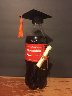 a bottle of alcohol with a graduation cap on top