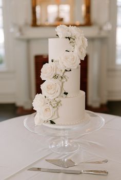 a wedding cake with white flowers on top