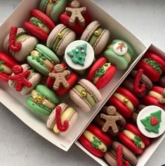 two boxes filled with different types of decorated cookies