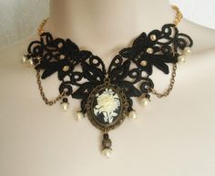 "This beautiful necklace has an antique gold filigree pendant with rose cameo setting, pearl beads, gold plated bead caps, seed beads, metal chain and black lace with rhinestone accents. It is 13\" long adjustable to 17\" long. Lobster clasp." Gold Gothic Wedding Jewelry, Elegant Antique Gold Necklaces For Gift, Elegant Antique Gold Necklace For Gift, Elegant Handmade Antique Gold Necklace, Gothic Gold Pendant Necklace, Gothic Gold Necklace For Wedding, Formal Bronze Cameo Jewelry, Vintage Filigree Baroque Necklace, Vintage Filigree Baroque Jewelry