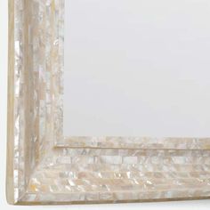 a white frame with mother of pearl in it