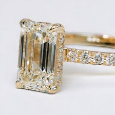 an engagement ring with a large diamond in the center and side stones on each band