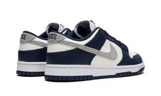 The Nike Dunk Low “Navy/White/Grey” is a classic and versatile colorway of the vintage basketball shoe that shows love to a popular, non-original Air Jordan 1 style.  The shoe in question is the Jordan 1 High OG “Midnight Navy” that originally debuted as part of Jordan Brand and Nike’s former Japan-only “Concept Japan” or Co. Jo collection.  Like the “Midnight Navy,” the “Navy/White/Grey” features a white leather base with contrasting navy leather overlays and a grey Swoosh.  As for the rest of the shoe, old school navy “Nike” branding is embroidered on the heel and navy “Nike” and Swoosh logos are found on the tongue tag. Good Shoes For Back To School, Navy Blue Nike Dunks, Best Shoes For School, Navy Blue Jordans, Navy Jordans, Navy Nike Shoes, Nike Dunks Low, Nike Jordan 1 Low, Jordan 1 Lows