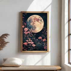 a painting hanging on the wall next to a bench with flowers in front of it