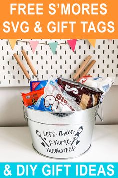 a bucket filled with candy and other items on top of a white table next to a sign