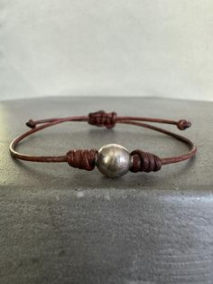 New from our Handmade Collection. Beautiful handmade brown leather and sterling silver ball adjustable bracelet. Adjustable Silver Leather Bracelet With Sliding Knot, Adjustable Silver Jewelry With Leather Strap, Classic Adjustable Silver Leather Bracelet, Classic Handmade Adjustable Leather Bracelet, Brown Leather Jewelry With Sliding Knot, Handmade Brown Sterling Silver Bracelets, Adjustable Silver Bracelet With Leather Strap, Nickel-free Brown Leather Bracelet As Gift, Adjustable Brown Sterling Silver Bracelets