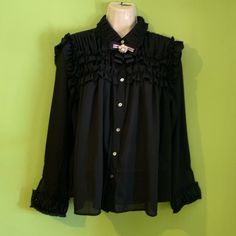 Black Long Sleeve Blouse Ruffle Details In Neck, Chest And Wrist, Pearl Buttons On Sleeves ( Wrist Button Only For Ornament Unless The Buttonhole Is Opened A Little More So That The Button Can Pass Through) Removable Bow Neck( Pin Brooch) Bought It In A Boutique. Never Worn, Victorian Style Button Up Blouse Black Ruffled Button-up Blouse, Black Button-up Top With Ruffles, Elegant Black Blouse With Buttons, Mustard Cardigan, Floral Halter Top, Black Long Sleeve Blouse, Linen Top Women, Lace Blouse Long Sleeve, Eyelet Blouse