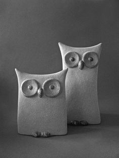 two ceramic owls sitting next to each other