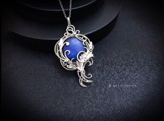 This Elven floral leaves necklace is wrapped in silver wire with dark blue Labradorite.                                                                                               It can be a unique decoration for a festive occasion or a lovely gift.                                                                                                                                                 Jewelry by Jewelryshore -https://jewelryshore.etsy.com Several techniques were used to create this beautiful pendant. This handmade item was soldered, forged, hammered, wrapped, oxidized (the silver part of the item ) then cleaned and polished to a high shine. All details are handmade.  The pendant requires careful handling and care. After a while, the metal slightly darkens. To restore the original Leaves Necklace, Floral Leaves, Witch Jewelry, Unique Decoration, Unique Gifts For Women, Labradorite Necklaces, Leaf Jewelry, Blue Labradorite, Leaf Necklace