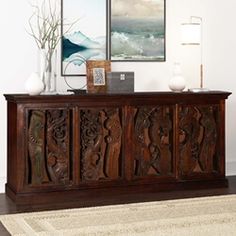 a large wooden cabinet sitting on top of a hard wood floor next to a rug