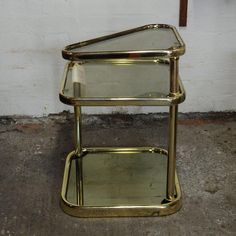 three tiered glass and brass side table