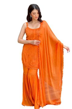 Orange straight kurta featuring chikankari embroidery with strap shoulder. Paired with a sharara and a lace embroidered dupatta. - Aza Fashions Sleeveless Sharara With Chikankari Embroidery For Festivals, Georgette Sharara With Dori Work, Traditional Sleeveless Sharara With Chikankari Embroidery, Traditional Sleeveless Palazzo Set With Dori Work, Sleeveless Salwar Kameez For Festivals, Chinon Palazzo Set With Dori Work, Georgette Palazzo Set With Cutdana, Semi-stitched Orange Sharara With Self Design, Orange Chanderi Sharara