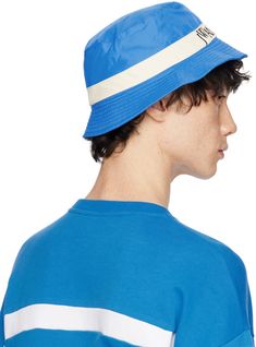 Nylon-blend taffeta bucket hat in blue. · Logo embroidered at face · Quilted brim Supplier color: Blue/White Blue Bucket Hat For Spring Outdoor, Sporty Blue Hats For Summer, Blue Bucket Hat For Spring Outdoor Activities, Blue Bucket Hat For Outdoor Spring Activities, Sporty Blue Summer Hats, Blue Cotton Bucket Hat With Flat Brim, Blue Bucket Hat For Outdoor, Blue Nylon Casual Hat, Blue Casual Nylon Hat