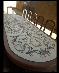 an oval table with chairs around it