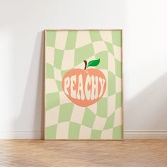 an apple with the word peachy written on it in front of a white wall