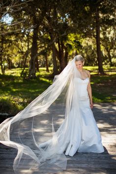 a woman in a white wedding dress and veil