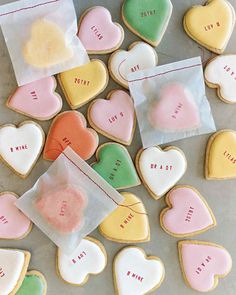 some heart shaped cookies are on a table and one has a piece of paper with the words i love you